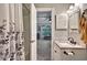Bathroom featuring decorative shower curtain, granite vanity and view to the Living Room at 4251 Hibiscus Dr. # 202, Little River, SC 29566