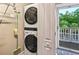 This condo features a convenient laundry area with a stacked washer and dryer at 4251 Hibiscus Dr. # 202, Little River, SC 29566