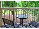 Balcony with a table and seating overlooking a serene outdoor view with trees at 4251 Hibiscus Dr. # 202, Little River, SC 29566
