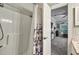 Shower with decorative curtain with view into the living room at 4251 Hibiscus Dr. # 202, Little River, SC 29566
