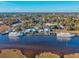 Scenic aerial view of a waterfront community with docked boats, a water tower, and lush trees at 4430 Eastport Blvd. # L-11, Little River, SC 29566