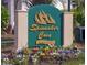 A welcoming Spinnaker Cove at Eastport sign surrounded by colorful flowers on a sunny day at 4430 Eastport Blvd. # L-11, Little River, SC 29566