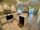 Kitchen with white cabinets and open view to living area at 4430 Eastport Blvd. # L-11, Little River, SC 29566
