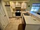 Kitchen with white cabinets and breakfast bar at 4430 Eastport Blvd. # L-11, Little River, SC 29566