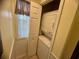 This is a laundry closet with stacked washer and dryer, as well as a window for natural light at 4430 Eastport Blvd. # L-11, Little River, SC 29566