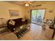 Living room with comfortable seating and access to balcony at 4430 Eastport Blvd. # L-11, Little River, SC 29566