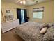 Comfortable bedroom with a ceiling fan, slider to the outside, lots of natural light, and dresser at 4430 Eastport Blvd. # L-11, Little River, SC 29566