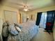 Comfortable main bedroom with a ceiling fan, sliding glass door to the outside, and ensuite bathroom access at 4430 Eastport Blvd. # L-11, Little River, SC 29566