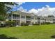 Backyard view of condos with screened porches and a large grassy area at 4430-G Montrose Ln. # G, Myrtle Beach, SC 29579