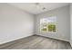 Bedroom showcasing light gray walls, window view, and wood-look flooring at 4430-G Montrose Ln. # G, Myrtle Beach, SC 29579