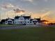 View of the clubhouse at sunset with manicured lawns and guest parking at 4430-G Montrose Ln. # G, Myrtle Beach, SC 29579