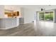 Living room with hardwood floors, kitchen, and screened in porch at 4430-G Montrose Ln. # G, Myrtle Beach, SC 29579