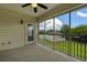 View of the screened porch with ceiling fan, door, and view of the community pool and blue sky at 4430-G Montrose Ln. # G, Myrtle Beach, SC 29579