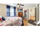 Comfortable bedroom featuring wood floors, complemented by a dresser, bookshelf, and window for natural light at 4477 Little River Inn Ln. # 1802, Little River, SC 29566