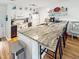 Bright kitchen featuring a large island with seating, white cabinets, and modern appliances at 4477 Little River Inn Ln. # 1802, Little River, SC 29566