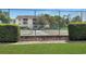 Community tennis court behind a green fence with trimmed hedges and adjacent condos at 4477 Little River Inn Ln. # 1802, Little River, SC 29566
