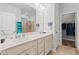 Bright bathroom featuring a double vanity, large mirror, and walk-in shower with glass door at 450 Oaklanding Ln., Murrells Inlet, SC 29576
