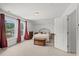 Light-filled bedroom with large windows, neutral decor, and views of the outdoors offering comfort and tranquility at 450 Oaklanding Ln., Murrells Inlet, SC 29576