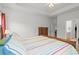 Bright bedroom featuring a wooden bed frame, colorful striped bedding and ensuite bathroom at 450 Oaklanding Ln., Murrells Inlet, SC 29576