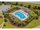 Aerial view of community pool featuring ample seating, covered area and mature landscaping at 450 Oaklanding Ln., Murrells Inlet, SC 29576