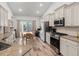 Well-lit kitchen with stainless steel appliances, granite countertops, and a dining area at 450 Oaklanding Ln., Murrells Inlet, SC 29576