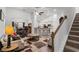 Open concept living room with vaulted ceilings, wood floors, and a staircase, seamlessly flowing into the kitchen at 450 Oaklanding Ln., Murrells Inlet, SC 29576