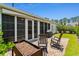 Inviting patio with rocking chairs, grill, and screened porch for relaxed outdoor living at 450 Oaklanding Ln., Murrells Inlet, SC 29576