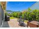 Charming patio with pavers, grill, garden bed, and rocking chairs surrounded by lush landscaping at 450 Oaklanding Ln., Murrells Inlet, SC 29576