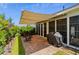 Relaxing patio area with retractable awning, grill, rocking chairs and verdant green grass at 450 Oaklanding Ln., Murrells Inlet, SC 29576