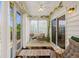Charming sunroom with ample light, sheer curtains, and decor, creating an inviting space for leisure and enjoyment at 450 Oaklanding Ln., Murrells Inlet, SC 29576