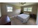 Comfortable bedroom with two windows, a ceiling fan, and neutral decor at 4637 Dogwood St., Loris, SC 29569