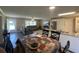 Open-concept living space with a dining table and chairs flowing into the kitchen and living room at 4637 Dogwood St., Loris, SC 29569