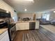 Modern kitchen with granite countertops, stainless steel appliances, hardwood floors, flowing into the living area at 4637 Dogwood St., Loris, SC 29569