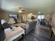 Open-concept living room featuring modern gray recliners, hardwood floors, and seamless flow to kitchen at 4637 Dogwood St., Loris, SC 29569