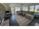 Bright and airy living room featuring a large sectional sofa, wood-look flooring, and ample natural light at 4637 Dogwood St., Loris, SC 29569