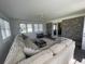 Inviting sunroom with large sectional sofa, tile floors, and a sliding glass door offering views of the backyard at 4637 Dogwood St., Loris, SC 29569
