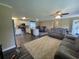 Spacious living area with modern furnishings, hardwood floors, connecting the kitchen and dining spaces at 4637 Dogwood St., Loris, SC 29569