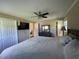 Cozy main bedroom featuring hardwood floors, a ceiling fan, and ensuite bath and closet at 4637 Dogwood St., Loris, SC 29569