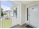View of a condo balcony with a white railing, exterior door and green shutter at 4924 Pond Shoals Ct. # 201, Myrtle Beach, SC 29579