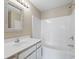 Clean bathroom with tub shower, white vanity with framed mirror and modern fixtures at 4924 Pond Shoals Ct. # 201, Myrtle Beach, SC 29579