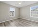 Neutral bedroom with plank floors, a ceiling fan and large windows at 4924 Pond Shoals Ct. # 201, Myrtle Beach, SC 29579