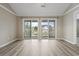 Bright bedroom boasting light wood floors and access to a balcony through sliding doors at 4924 Pond Shoals Ct. # 201, Myrtle Beach, SC 29579