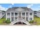 Inviting exterior view of a two-story condo with white railings and green shutters at 4924 Pond Shoals Ct. # 201, Myrtle Beach, SC 29579