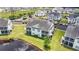 Exterior view of condo featuring screened-in porches and manicured lawn near a pond at 4924 Pond Shoals Ct. # 201, Myrtle Beach, SC 29579