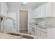 Well-lit kitchen features white cabinets, granite countertops, and modern appliances at 4924 Pond Shoals Ct. # 201, Myrtle Beach, SC 29579