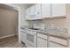 A well-equipped kitchen with modern white appliances, stylish countertops, and ample storage at 4924 Pond Shoals Ct. # 201, Myrtle Beach, SC 29579