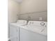 Amana washer and dryer set with wire rack shelving above in the laundry room at 4924 Pond Shoals Ct. # 201, Myrtle Beach, SC 29579