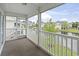 Screened-in porch overlooking lake, landscaping, and other residential buildings at 4924 Pond Shoals Ct. # 201, Myrtle Beach, SC 29579