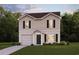 Charming two-story home featuring vertical siding, black shutters, an attached garage and a well-maintained lawn at 495 Sw Hewett Landing Dr., Supply, SC 28462