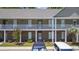 Inviting two-story condo building with brick and siding, complemented by well-maintained landscaping at 50 Turning Stone Blvd. # 7, Murrells Inlet, SC 29576